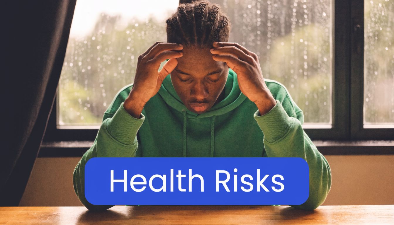 A person sitting at a desk appearing stressed or in pain with a blue health risks label overlay.
