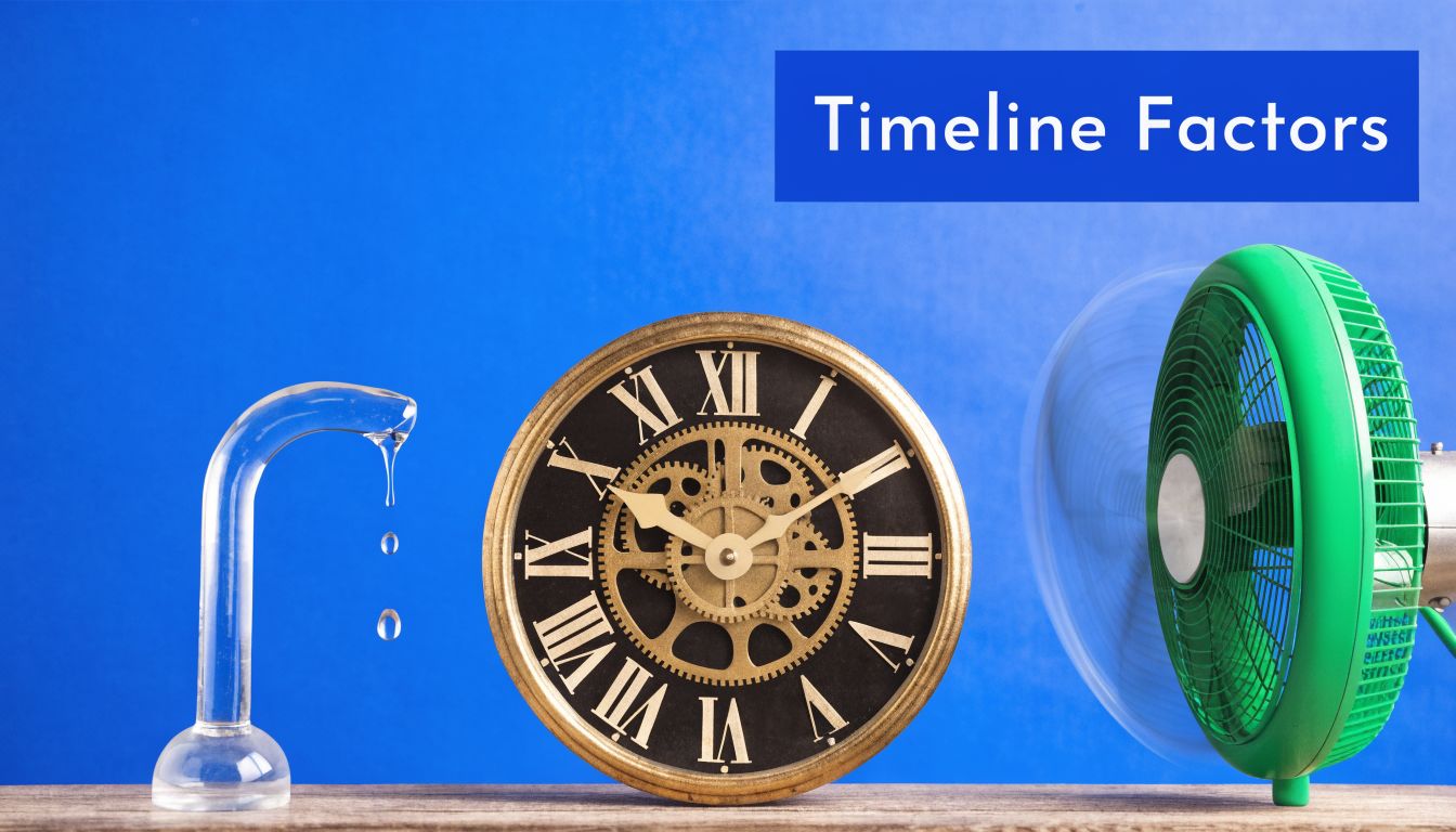 A glass water dropper, an antique clock, and a spinning green electric fan on a wooden surface.