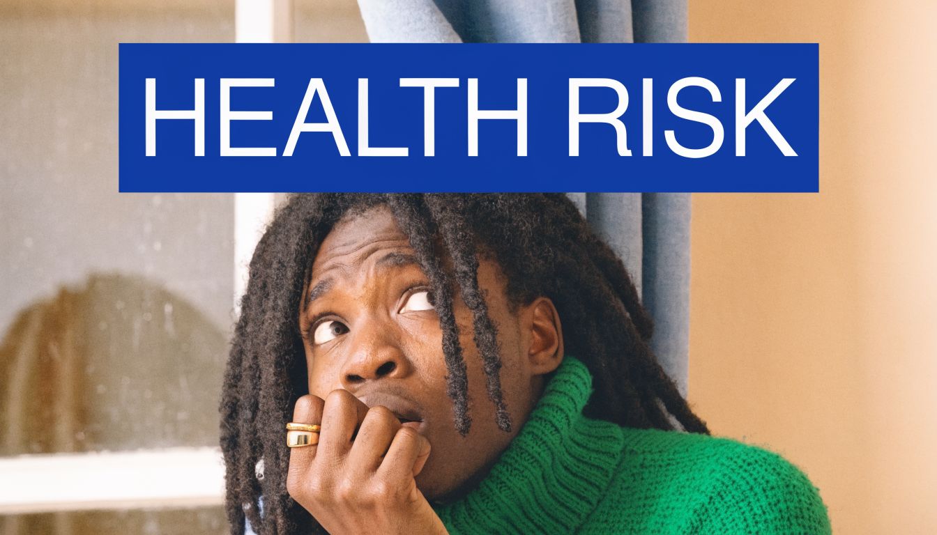 A person with dreadlocks looks concerned and anxious near a window with the text health risk above.